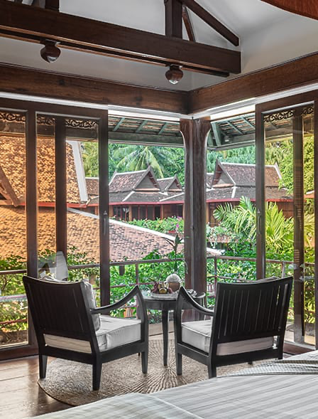 Private balcony with armchairs overlooking the palm gardens